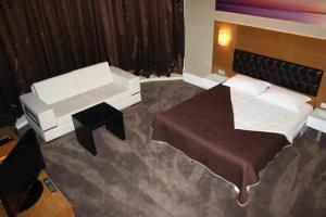 A bed or beds in a room at City Hotel Plovdiv