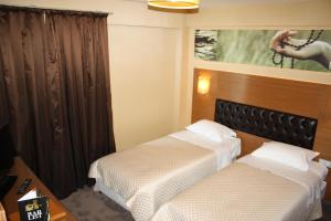 Giường trong phòng chung tại City Hotel Plovdiv