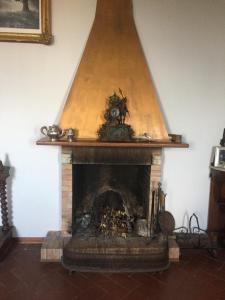 a fireplace in a room with a stairwayarmaangering at Villa Eugenia in Livorno