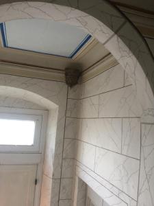 a bathroom with a window and a white marble wall at Villa Eugenia in Livorno