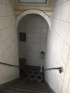 a bathroom with a shower and stairs in a building at Villa Eugenia in Livorno