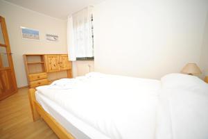 a bedroom with two beds and a window at Apartamenty Haffnera by Grand Apartments in Sopot