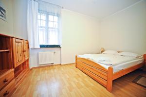 a bedroom with a bed and a large window at Apartamenty Haffnera by Grand Apartments in Sopot