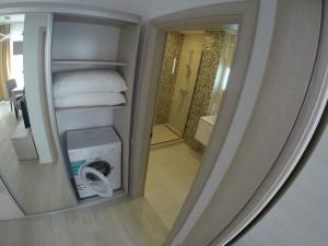 a reflection of a room with a bed and a bathroom at Lotus nr 9 Mamaia Apartments Sea View in Mamaia