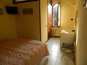 a bedroom with a bed and a sink and a window at Albergo Michieletto in Valmorea +40 photos