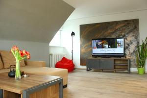 a living room with a flat screen tv on a wall at Holiday Home Kötz in Günzburg