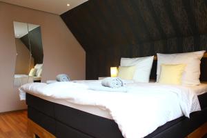 a bedroom with a large bed with a black headboard at Holiday Home Kötz in Günzburg