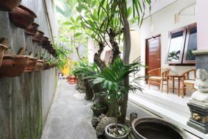 a corridor of a building with trees and plants at Anantaya Home in Denpasar