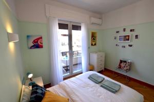 a small bedroom with a bed and a window at Spacious & Sunny Kolonaki Apt 5 mins metro/ACx3/1.5 BT in Athens