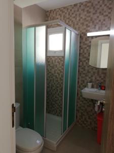 a bathroom with a shower and a toilet and a sink at Chicos Studios in Ayia Napa +151 photos