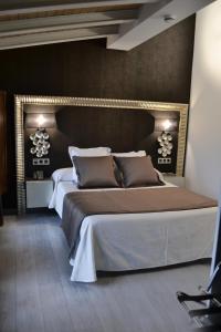 A bed or beds in a room at Hotel Rural Villa de Berlanga