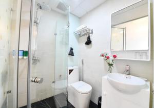 a bathroom with a toilet and a sink and a shower at Bella Rosa Trendy Hotel & Spa in Hanoi