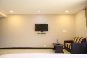 a waiting room with a flat screen tv on the wall at Hotel Golden Gateway in Vellore