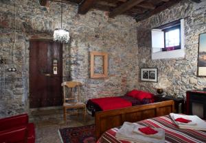 a bedroom with a bed in a stone wall at I Glicini in Lerici