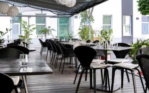 a row of tables and chairs in a restaurant at Maverick Budapest Soho in Budapest