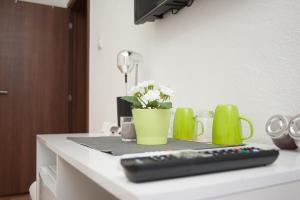 a remote control sitting on top of a kitchen counter at Vila Vanila in Gevgelija