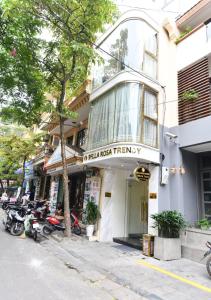 a street with motorcycles parked in front of a store at Bella Rosa Trendy Hotel & Spa in Hanoi