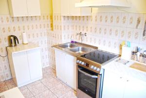 a kitchen with a sink and a stove top oven at HelApart - Helium in Hel +13 photos
