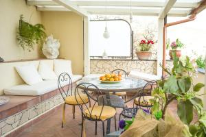 a patio with a table and chairs and a couch at La Residenza Dei Mori - Taormina Holidays in Taormina