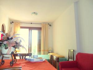 a living room with a table and a window at Appartamenti Galatea in Palau