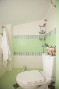 a bathroom with a white toilet and a sink at Blue Luxury Maison in Possidi