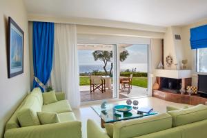 a living room with a couch and a table at Blue Luxury Maison in Possidi