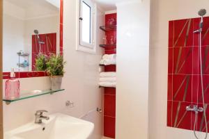 a bathroom with a sink and a shower at Blue Luxury Maison in Possidi