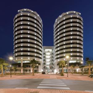 two tall buildings in a city at night at Torri Camuzzi Exclusive Luxury Apartment in Pescara