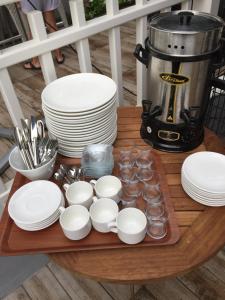 a table with plates and cups and dishes on it at Göcek Centre Hotel in Göcek