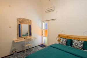 A bed or beds in a room at The Bodhi Tree Karimunjawa