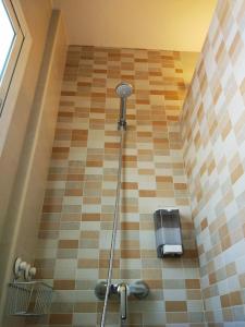 a shower in a bathroom with a tiled floor at La Luna in Marbella