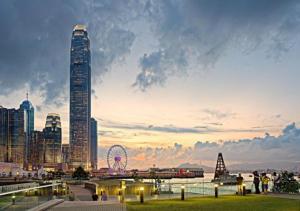 a city skyline with a ferris wheel and a tall building at Premium Lounge in Hong Kong