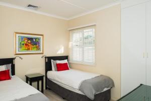 a bedroom with two beds and a window at Long Island 42 in Ballito