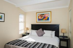 a bedroom with a large bed with two lamps at Long Island 42 in Ballito