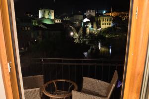 a view of a city at night from a balcony at Pansion Villa Nur in Mostar