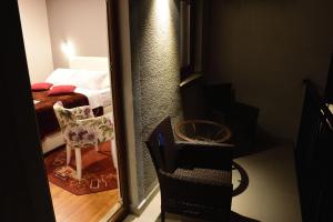 a room with a mirror and a bedroom with a bed at Pansion Villa Nur in Mostar