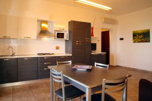 a kitchen with a table and chairs in a room at Agriturismo San Gregorio in San Vincenzo