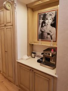 a kitchen with a microwave and a picture of a woman at Da Domenico Am Hagelkreuz in Hilden