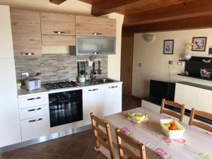 a kitchen with a table and a stove top oven at Casa Zagara in Avola