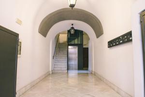 a hallway with a staircase in a building at B&B Chiaia 32 in Naples