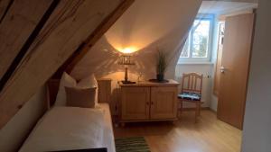 a bedroom with a bed and a lamp in a attic at Mettner Hof in Metten
