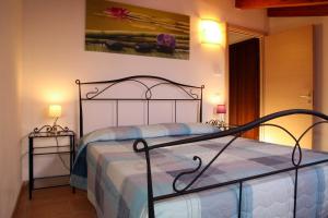 a bedroom with a bed with a metal frame at Agriturismo San Gregorio in San Vincenzo
