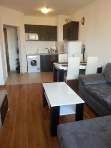 a living room with a couch and a table at Belveder Holiday Club Private in Bansko