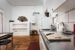 a kitchen with a counter top with a refrigerator at 3 Bedroom Apartment (ACERE) in Berlin