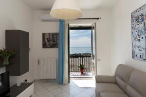 a living room with a couch and a view of the ocean at Mare mìa in Salerno