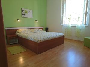 a bedroom with a bed in a room with a window at Apartment Spalatina in Split