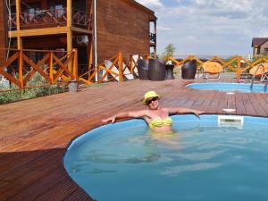 a woman in a swimming pool on a deck at Арасан Алаколь in Qabanbay