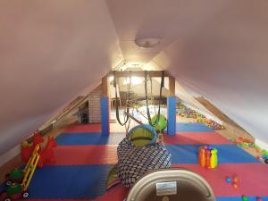 an attic room with a play room with a playground at Vila na Skalce in Česká Kamenice
