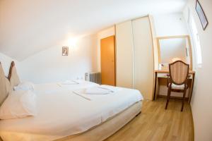 1 dormitorio con cama, escritorio y silla en Apartments Luka en Budva