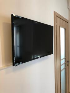 a flat screen tv hanging on a wall at Studio Confort 3 in Bucharest